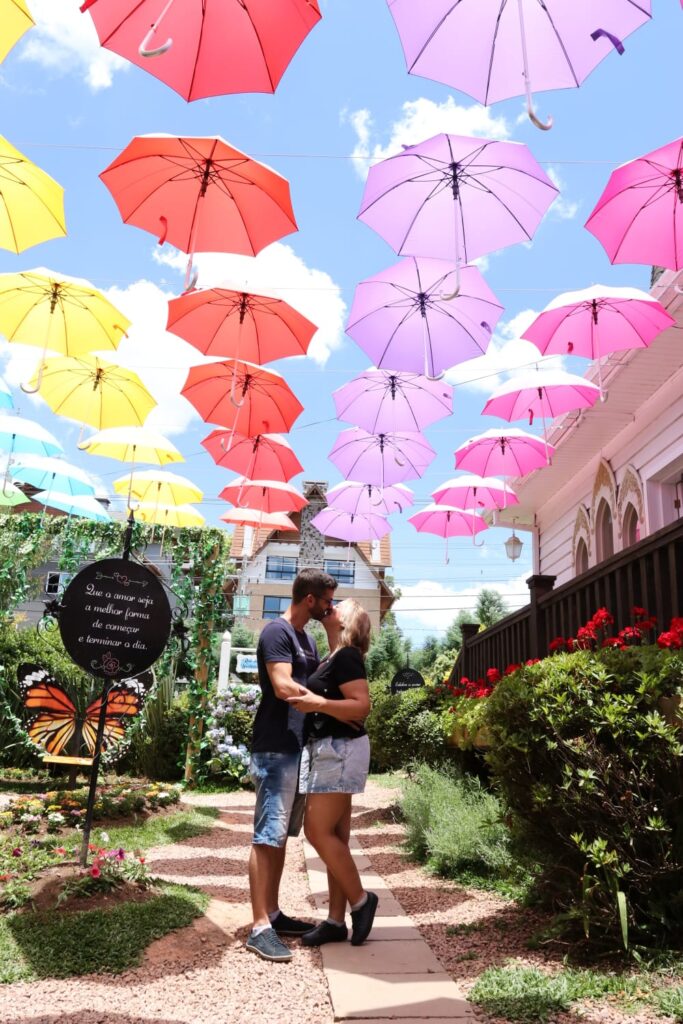 Casal e guarda-chuvas coloridos Jardim do Amor Gramado